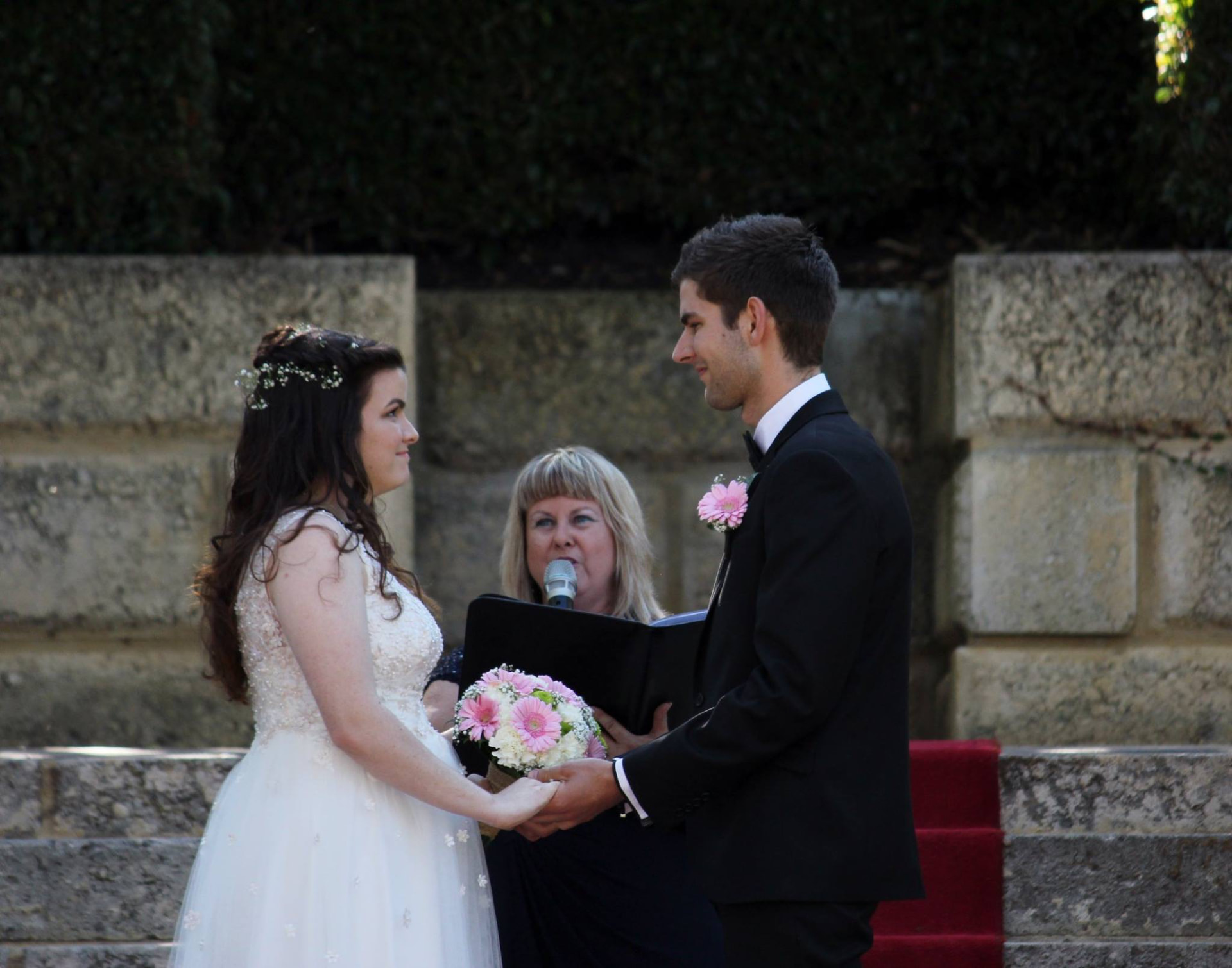 Julie marrying Davin and Madi in front of limestone steps